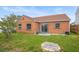 Backyard featuring a grassy area, a covered well, and a sliding glass door leading into the home at 7591 121St Ter, Largo, FL 33773