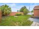 Expansive backyard with a palm tree, a seating area, a garden, and plenty of space to entertain at 7591 121St Ter, Largo, FL 33773