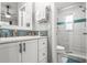 Bathroom featuring a white vanity, a modern shower with blue tile accents, and updated fixtures at 7591 121St Ter, Largo, FL 33773