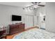 Bright bedroom with high ceilings and a floral-patterned bedspread with access to the bathroom at 7591 121St Ter, Largo, FL 33773