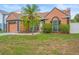 Beautiful single-Gathering house boasting well-kept lawn, garden and a healthy palm tree at 7591 121St Ter, Largo, FL 33773