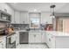 Bright kitchen with white cabinets, stainless steel appliances, and modern backsplash at 7591 121St Ter, Largo, FL 33773