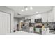 Kitchen featuring stainless steel appliances, white cabinets, and views to the back yard at 7591 121St Ter, Largo, FL 33773