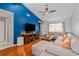 Cozy living room featuring hardwood floors, a comfortable sectional couch, and a ceiling fan at 7591 121St Ter, Largo, FL 33773