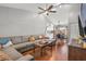 Bright and open living room with hardwood floors, sectional seating, and vaulted ceilings at 7591 121St Ter, Largo, FL 33773