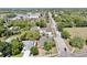 Aerial view showcasing a house with a pool, lush greenery, and the neighborhood streets at 829 Riverside Dr, Tarpon Springs, FL 34689