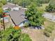 Overhead view of a well-maintained home, accented by lush trees and greenery in a serene neighborhood setting at 829 Riverside Dr, Tarpon Springs, FL 34689