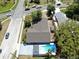 An aerial view of a home showcasing a backyard swimming pool, spacious yard, and the surrounding neighborhood streets at 829 Riverside Dr, Tarpon Springs, FL 34689