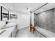 Modern bathroom features grey marble walk-in shower and grey vanity with black hardware at 829 Riverside Dr, Tarpon Springs, FL 34689
