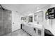 Modern bathroom featuring dual sinks, stylish mirrors, and updated shower at 829 Riverside Dr, Tarpon Springs, FL 34689