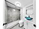 Modern bathroom features a sleek vanity with blue glass bowl sink and tiled walk-in shower at 829 Riverside Dr, Tarpon Springs, FL 34689