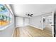Bedroom featuring a ceiling fan, neutral walls, wood-look floors, and dual closets at 829 Riverside Dr, Tarpon Springs, FL 34689