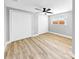 Bright bedroom features two closets, light walls, window and light wood-look flooring at 829 Riverside Dr, Tarpon Springs, FL 34689