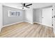 Bedroom with light walls, ceiling fan, window and light wood-look flooring at 829 Riverside Dr, Tarpon Springs, FL 34689