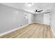 Bedroom with light walls, ceiling fan, windows, and light wood-look flooring at 829 Riverside Dr, Tarpon Springs, FL 34689