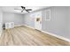Spacious bedroom with a modern ceiling fan, wood-look flooring, and neutral paint at 829 Riverside Dr, Tarpon Springs, FL 34689