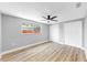 Bedroom featuring a ceiling fan, wood-look floors, and dual closets at 829 Riverside Dr, Tarpon Springs, FL 34689