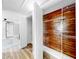 Walk-in closet with custom wood paneling, shelving, and wood-look floors at 829 Riverside Dr, Tarpon Springs, FL 34689