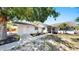 Charming single-story home featuring a well-maintained front yard, beautiful landscaping, and a welcoming entrance at 829 Riverside Dr, Tarpon Springs, FL 34689