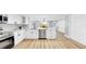 Well-lit kitchen featuring white cabinets and an island with stainless steel appliances at 829 Riverside Dr, Tarpon Springs, FL 34689