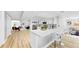 Modern kitchen with sleek white cabinetry, stainless steel appliances, a breakfast bar, and open access to the living spaces at 829 Riverside Dr, Tarpon Springs, FL 34689
