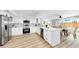 Bright, updated kitchen with white cabinetry, stainless steel appliances, and an island perfect for entertaining at 829 Riverside Dr, Tarpon Springs, FL 34689