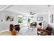 Bright living room with hardwood floors, stylish furniture, and a modern ceiling fan at 829 Riverside Dr, Tarpon Springs, FL 34689