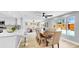Beautiful living area with an open floor plan, seamlessly connecting the kitchen, dining space, and living room with pool views at 829 Riverside Dr, Tarpon Springs, FL 34689