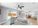 Open living room boasts sliding glass doors to the pool, as well as an open concept to the dining room at 829 Riverside Dr, Tarpon Springs, FL 34689