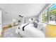 Bright main bedroom featuring a ceiling fan, large window, neutral walls, and wood-look floors at 829 Riverside Dr, Tarpon Springs, FL 34689