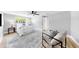 Spacious main bedroom with a ceiling fan, gray walls, wood-look flooring, and a chair at 829 Riverside Dr, Tarpon Springs, FL 34689