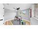 Bright office space features a modern ceiling fan, a large window, and stylish decor at 829 Riverside Dr, Tarpon Springs, FL 34689