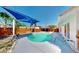 Backyard pool with new deck, blue shade cover and mature trees for shade at 829 Riverside Dr, Tarpon Springs, FL 34689