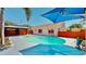 Backyard pool with a new deck, integrated steps, and blue shade cover at 829 Riverside Dr, Tarpon Springs, FL 34689