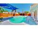 Backyard pool with new deck, blue shade cover and mature trees for shade at 829 Riverside Dr, Tarpon Springs, FL 34689