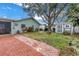 Charming backyard featuring a brick patio, storage shed, and lush landscaping at 9611 107Th N Ave, Largo, FL 33773