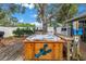 This backyard features a brick patio and wooden hot tub for relaxing and entertaining at 9611 107Th N Ave, Largo, FL 33773