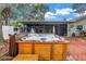 Enjoy this backyard with a wooden hot tub, brick patio and screened-in porch at 9611 107Th N Ave, Largo, FL 33773