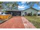 Backyard with hot tub, brick patio, screened in porch and lush landscaping at 9611 107Th N Ave, Largo, FL 33773