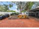 This backyard features a brick patio and wooden hot tub perfect for outdoor entertaining at 9611 107Th N Ave, Largo, FL 33773