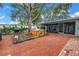 Relax and unwind in this backyard featuring a brick patio and wooden hot tub at 9611 107Th N Ave, Largo, FL 33773