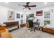 Spacious carpeted room featuring dual windows, wood furnishings, and decorative wall art at 9611 107Th N Ave, Largo, FL 33773