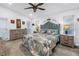 Bright bedroom with a unique blue headboard, beachy decor, and ample natural light from the two windows at 9611 107Th N Ave, Largo, FL 33773