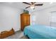 Bedroom featuring soft blue bedding, a wooden wardrobe, a wooden trunk, and neutral carpeting at 9611 107Th N Ave, Largo, FL 33773