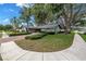 Charming single-story home with lush landscaping, mature trees, and a brick driveway at 9611 107Th N Ave, Largo, FL 33773
