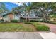 Charming single-story home with well-maintained landscaping and a brick driveway at 9611 107Th N Ave, Largo, FL 33773