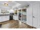 Bright kitchen with white cabinets, stainless steel appliances, and sliding glass door to the outside at 9611 107Th N Ave, Largo, FL 33773