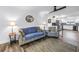 Open-concept living room with sofa, chair and coffee table, seamlessly connecting to the updated kitchen at 9611 107Th N Ave, Largo, FL 33773