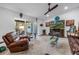 Inviting living room with a cozy fireplace, comfortable seating, and sliding glass doors to the outside at 9611 107Th N Ave, Largo, FL 33773
