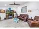 Spacious living room with comfortable seating, a fireplace, and a large TV at 9611 107Th N Ave, Largo, FL 33773